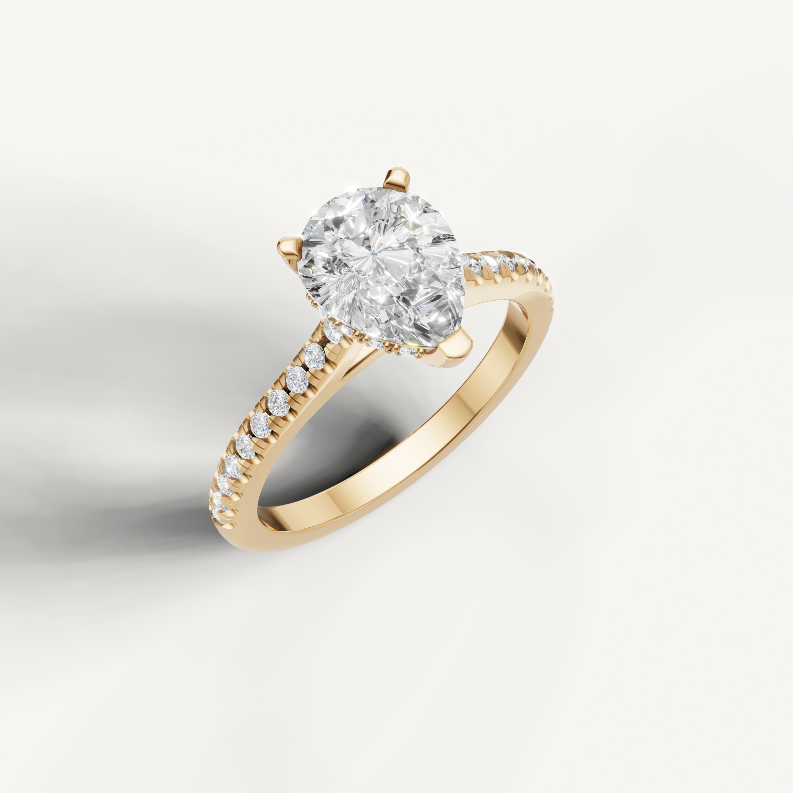 Elegant pear shaped lab grown diamond solitaire ring in yellow gold with slim pavé diamond band