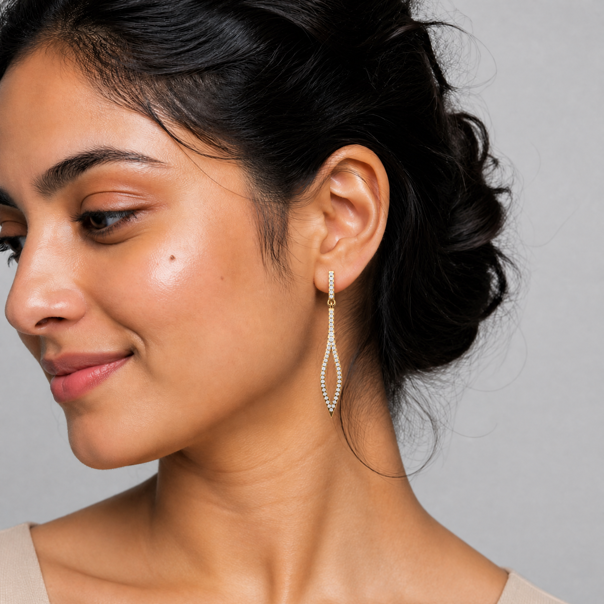 Model wearing Raul Diamonds luxury diamond marquise drop earrings in gold finish