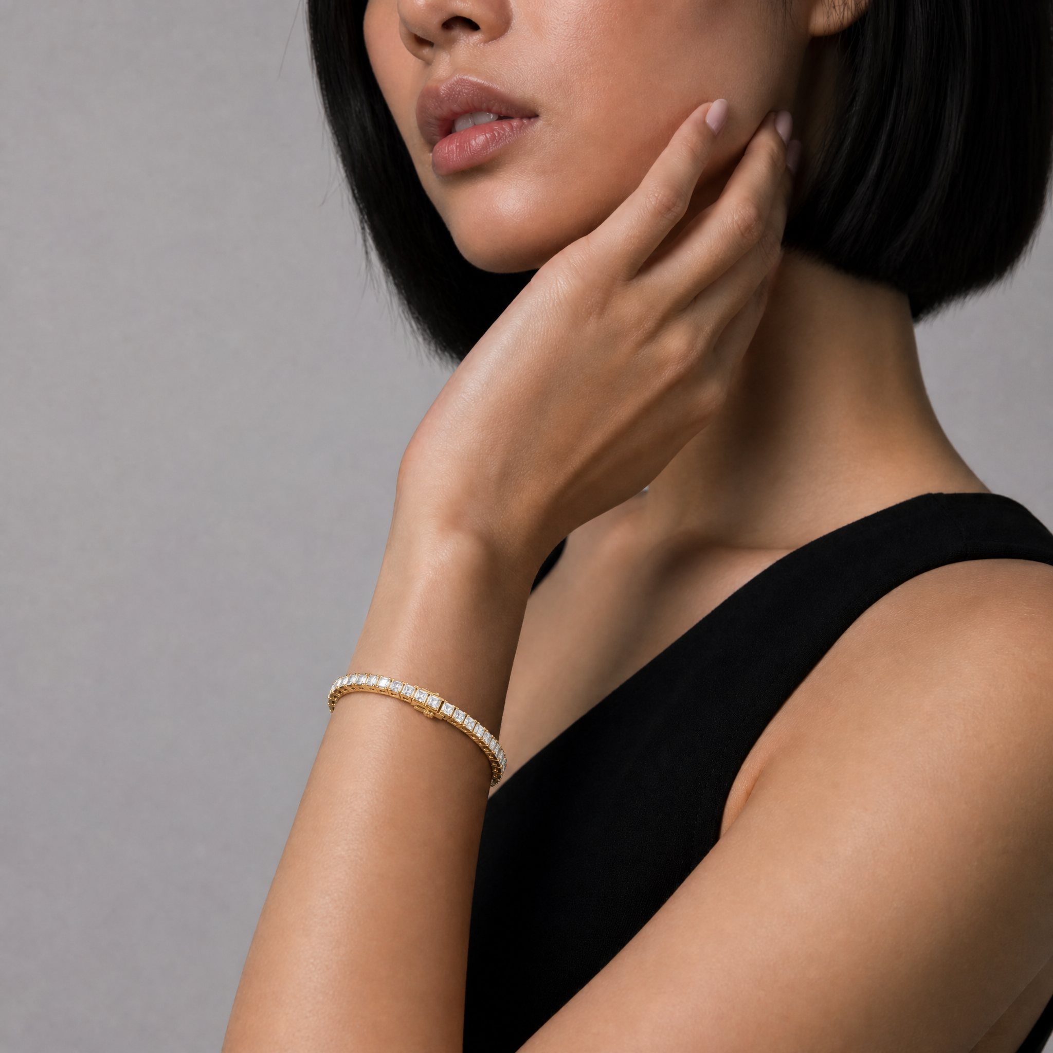 Model wearing Raul Diamonds princess cut diamond tennis bracelet in yellow gold