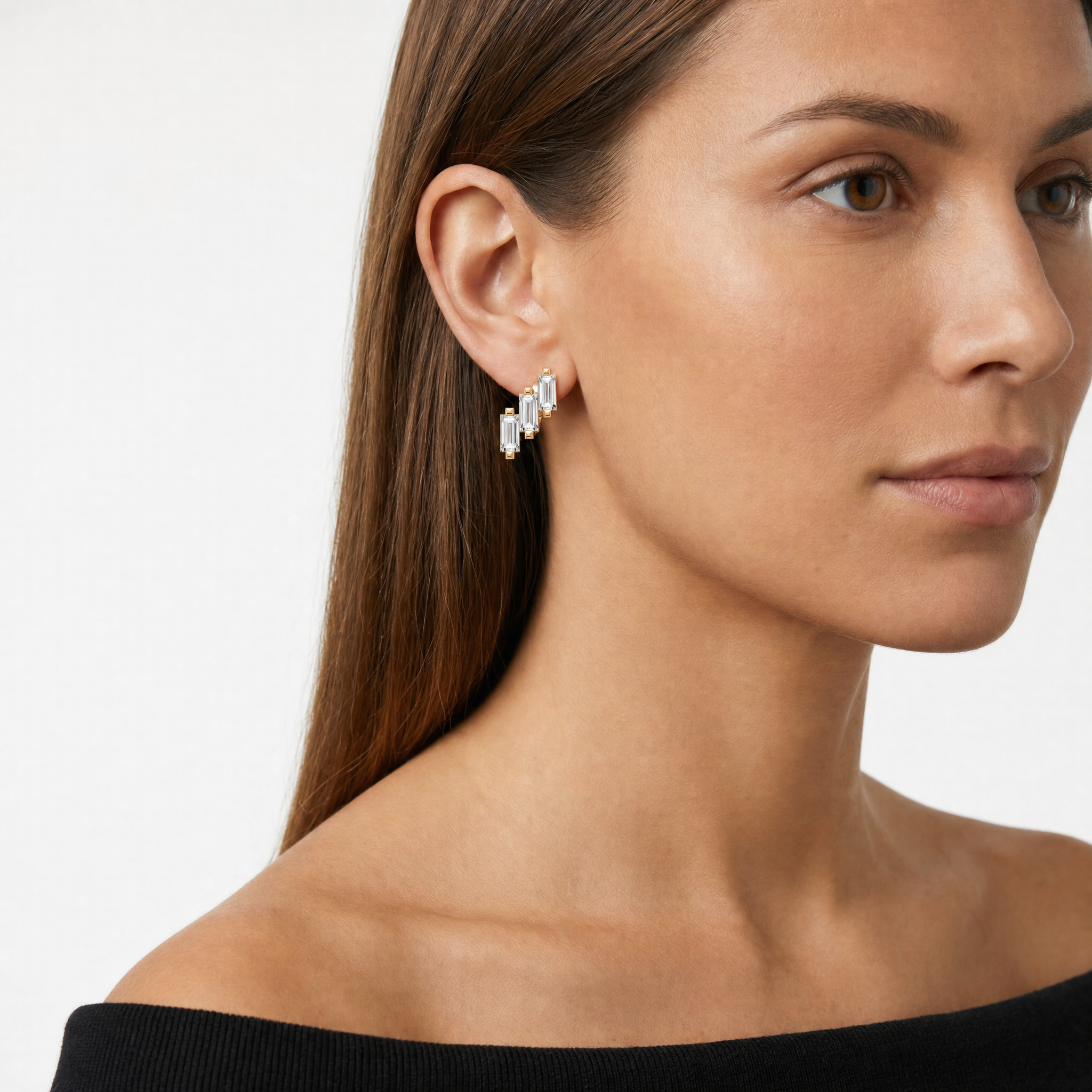 Female model wearing Raul Diamonds baguette diamond hoop earrings in rose gold