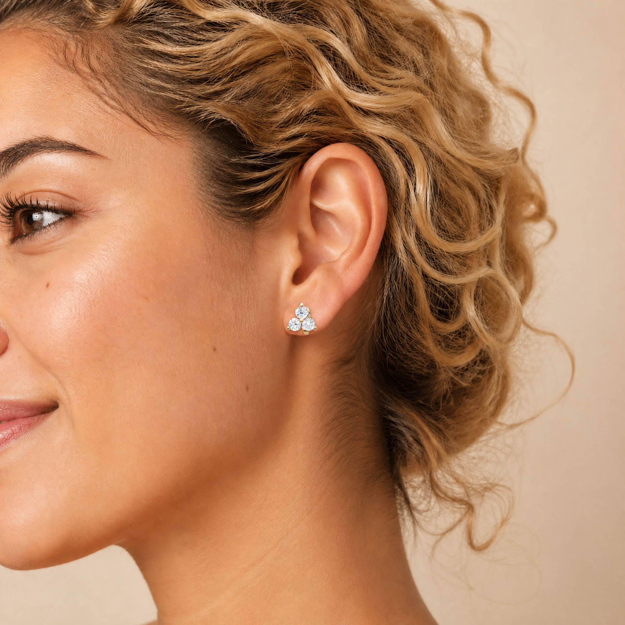 Model wearing Raul Diamonds rose gold three stone diamond stud earrings with elegant luxury styling