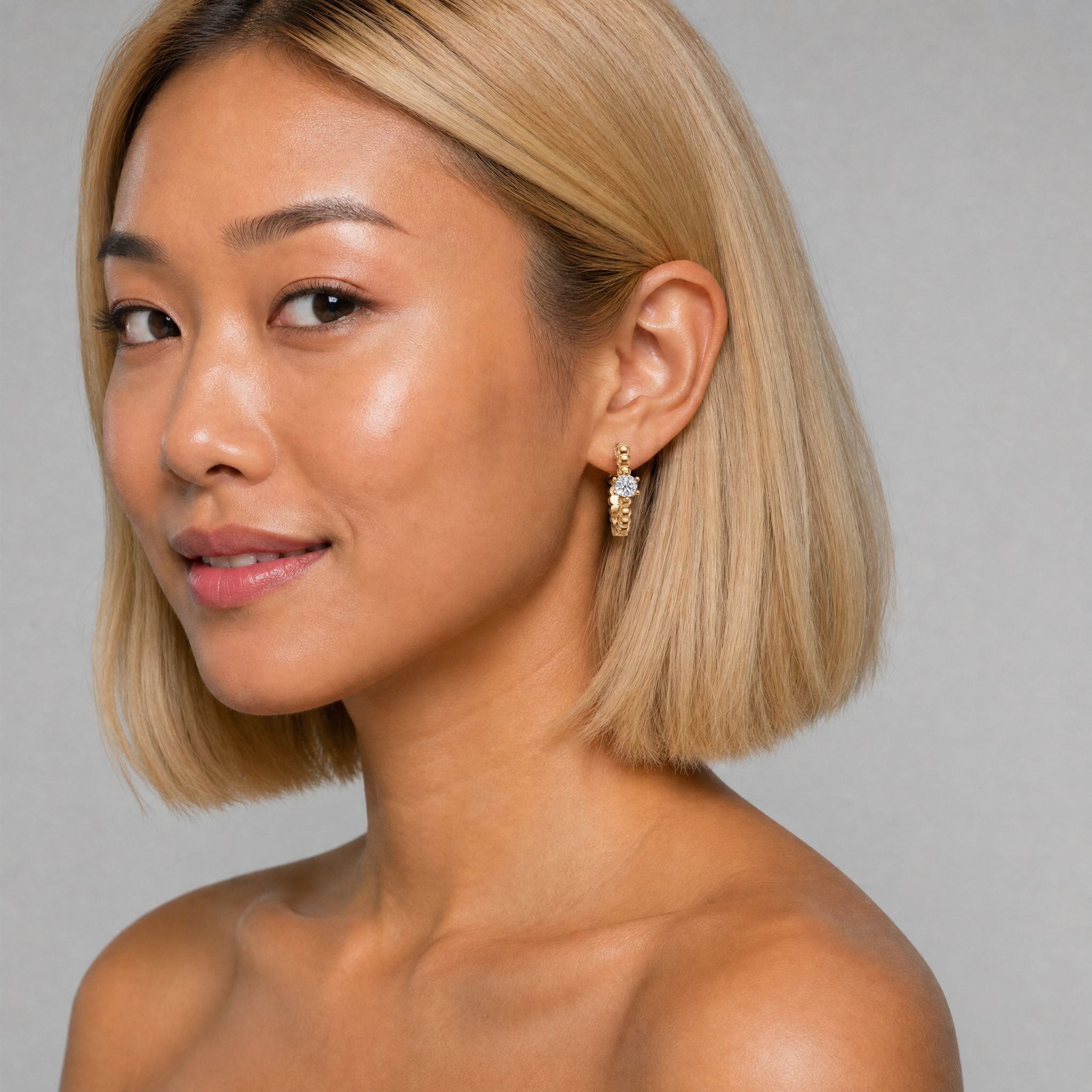 Female model wearing Raul Diamonds beaded solitaire diamond hoop earrings