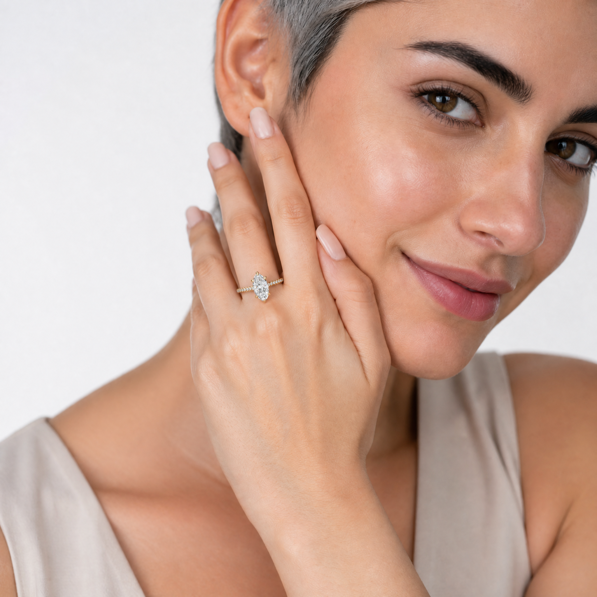 Model Amelia Hart wearing Raul Diamonds marquise cut yellow gold engagement ring with pavé diamond band and luxury bridal styling