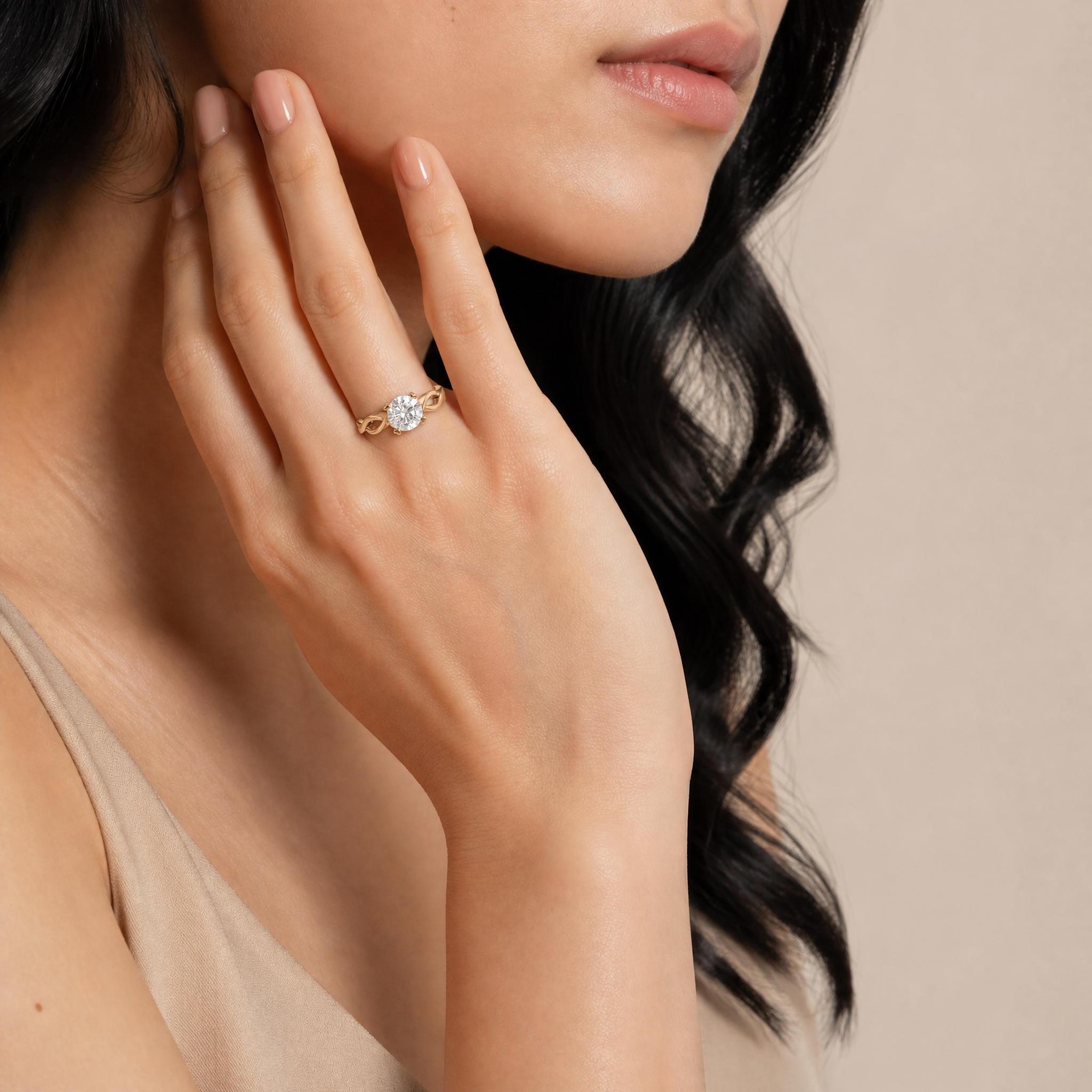 Woman wearing Raul Diamonds emerald cut solitaire engagement ring with elegant twist band design.