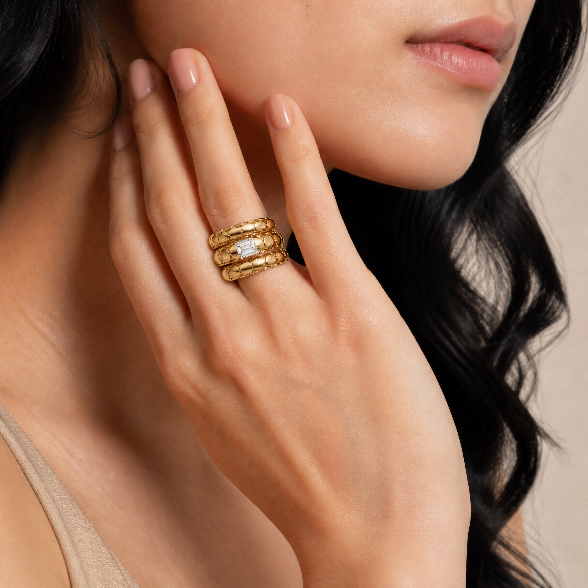Model wearing Raul Diamonds emerald cut diamond wrap ring in polished yellow gold
