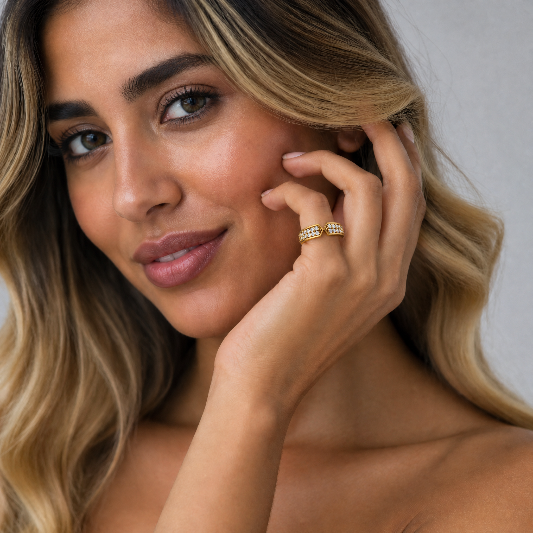Female model wearing Raul Diamonds yellow gold geometric pavé diamond wedding band with elegant bridal styling