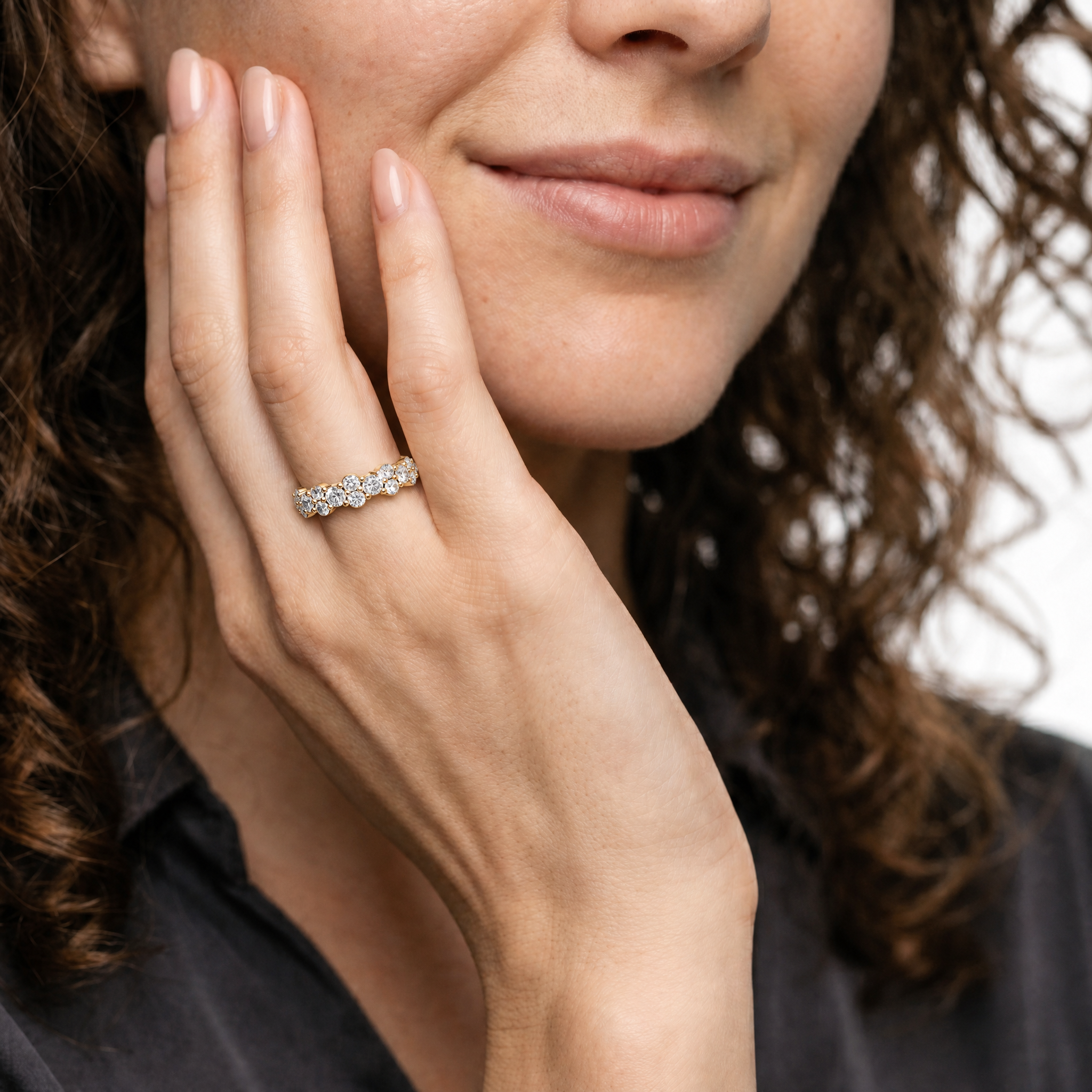 Female model wearing Raul Diamonds yellow gold floral diamond wedding band with elegant bridal styling