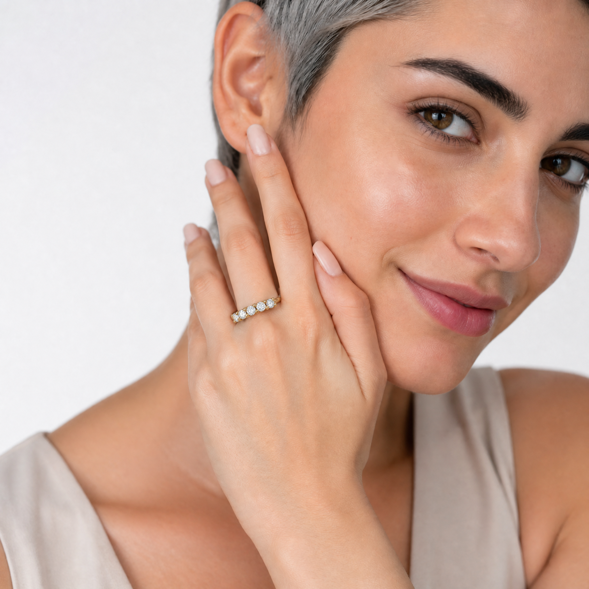 Female model wearing Raul Diamonds yellow gold five stone diamond wedding band with elegant bridal jewelry styling