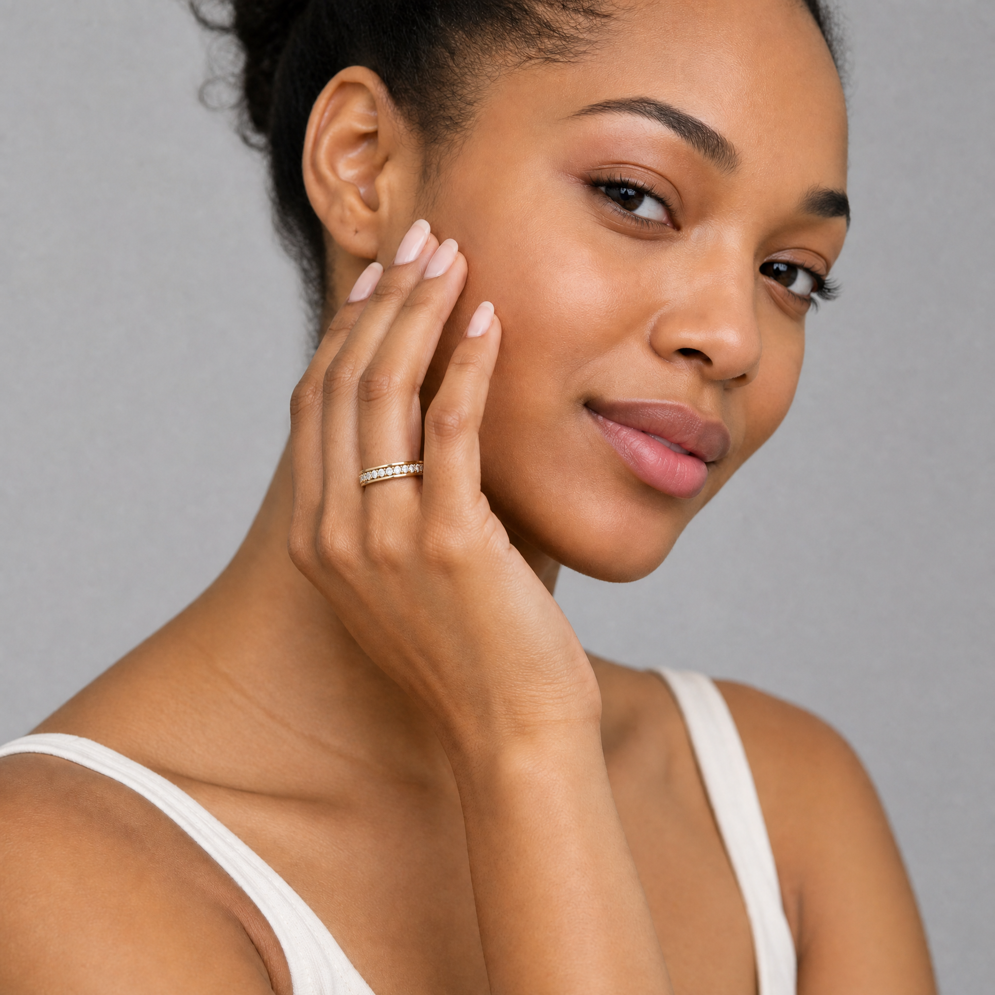 Model wearing Raul Diamonds channel set diamond wedding band in yellow gold bridal style
