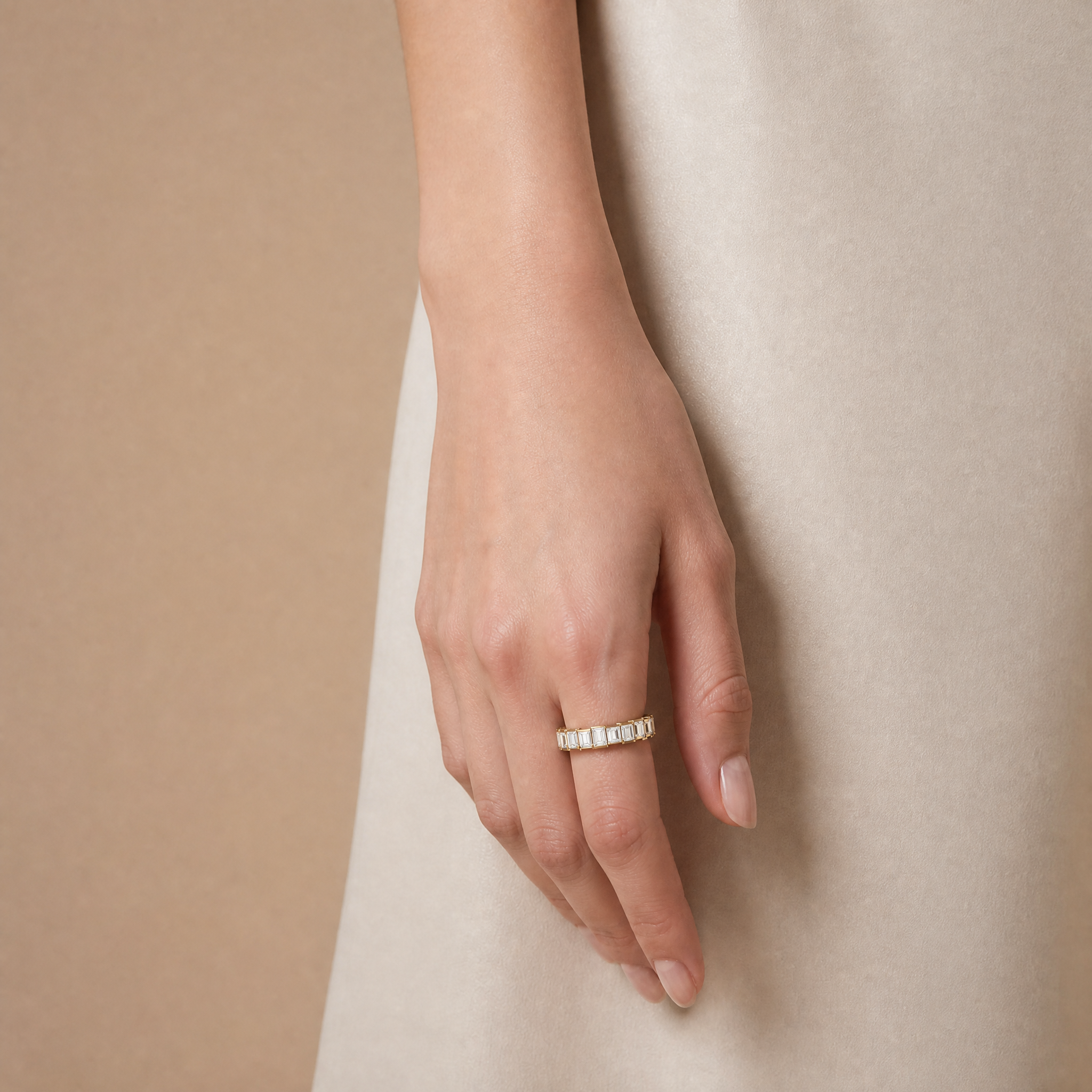 Model wearing Raul Diamonds emerald cut diamond wedding band in luxurious yellow gold finish