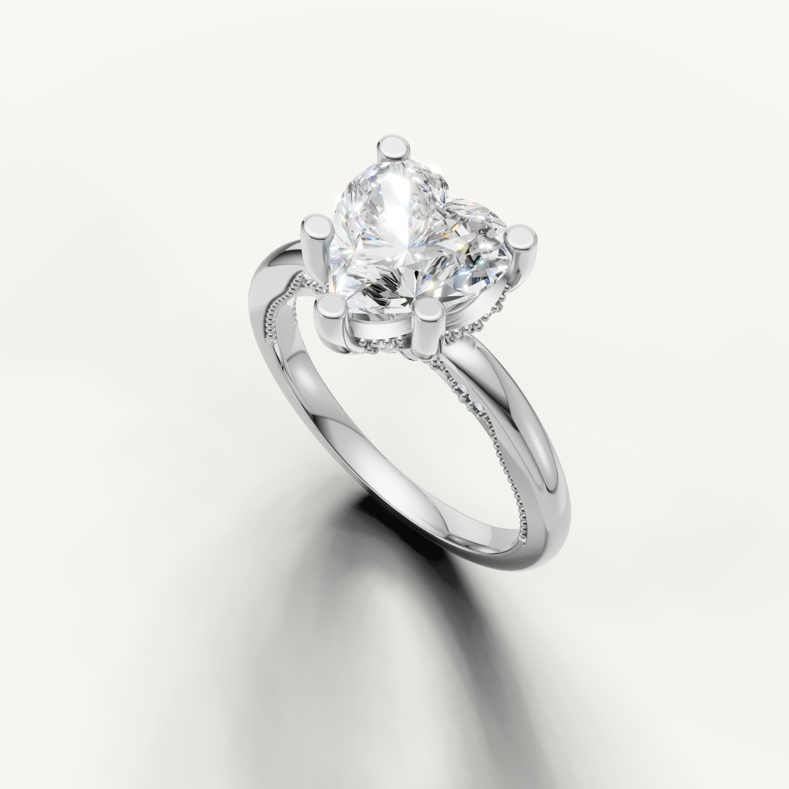 A high-polish white metal solitaire ring showcasing the sharp, lovely lines of a large heart-shaped diamond.