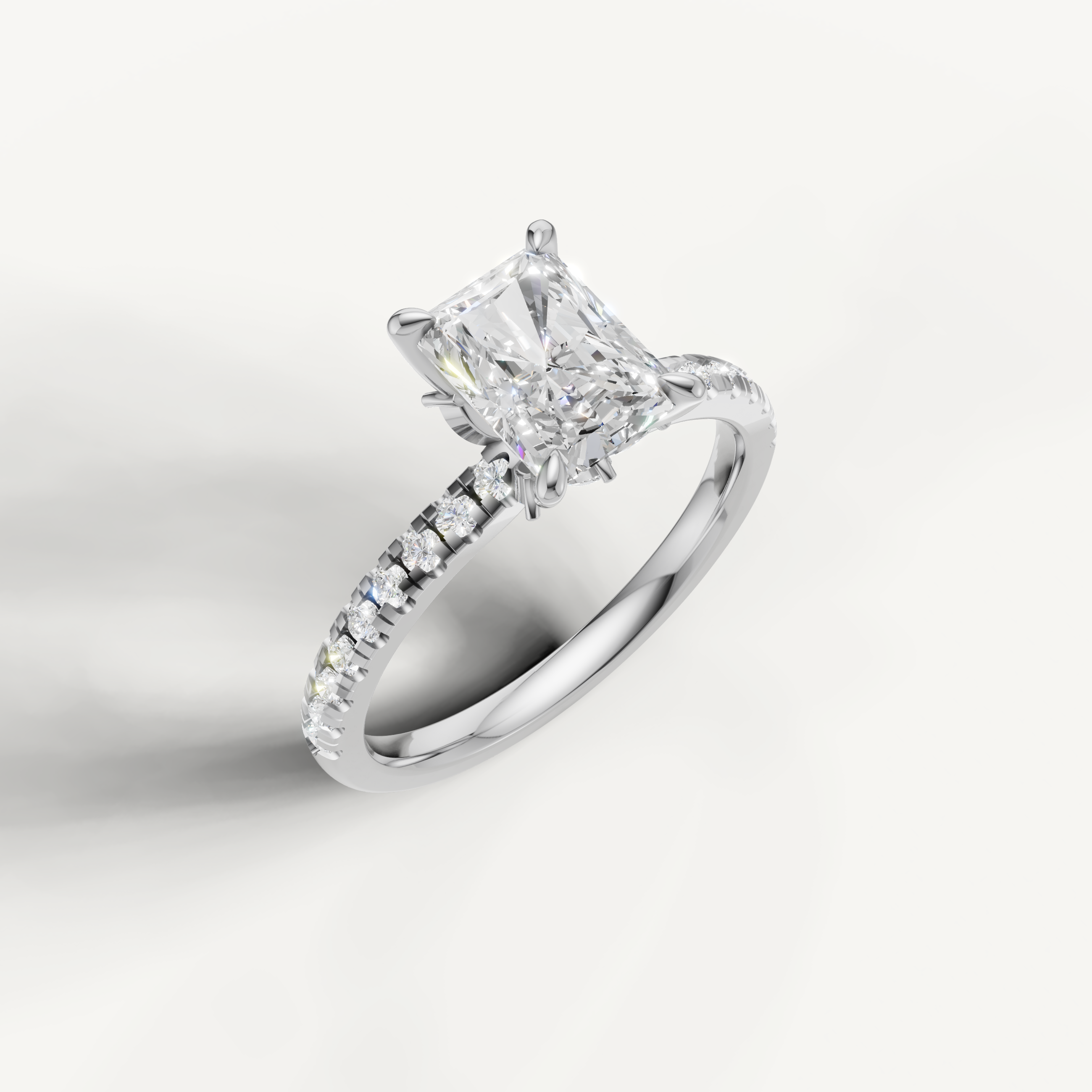 White gold radiant diamond ring featuring a hidden halo design and brilliant pavé diamonds, by Raul Diamonds.