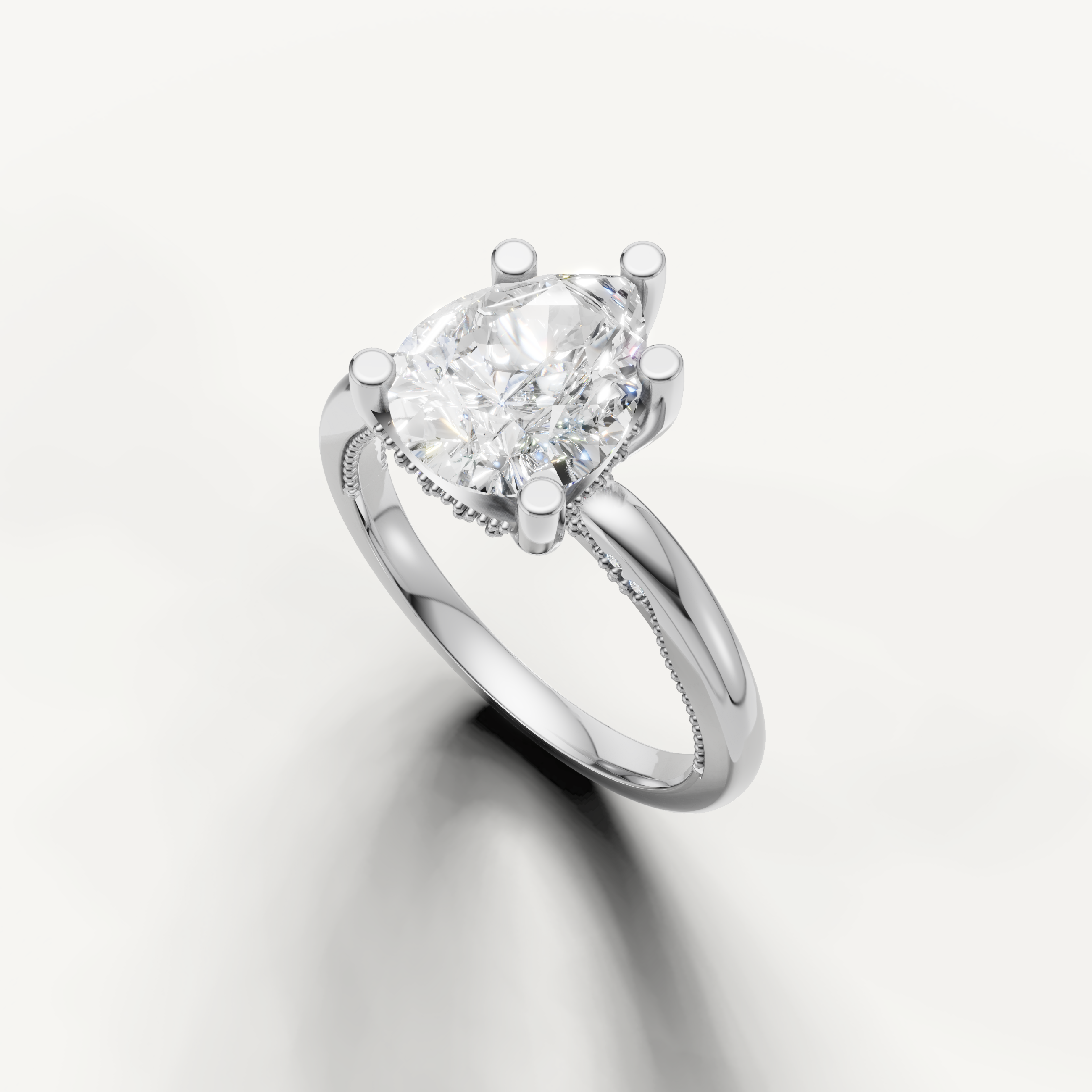 A high-polish white metal solitaire ring showcasing the sophisticated, teardrop shape of a large pear-cut diamond.