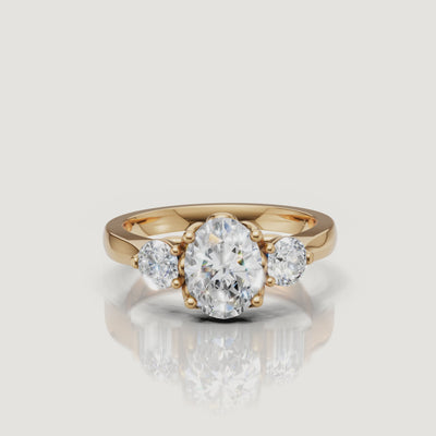 Yellow Gold Video Alt Text: Raul Diamonds oval diamond engagement ring video in yellow gold with side stones