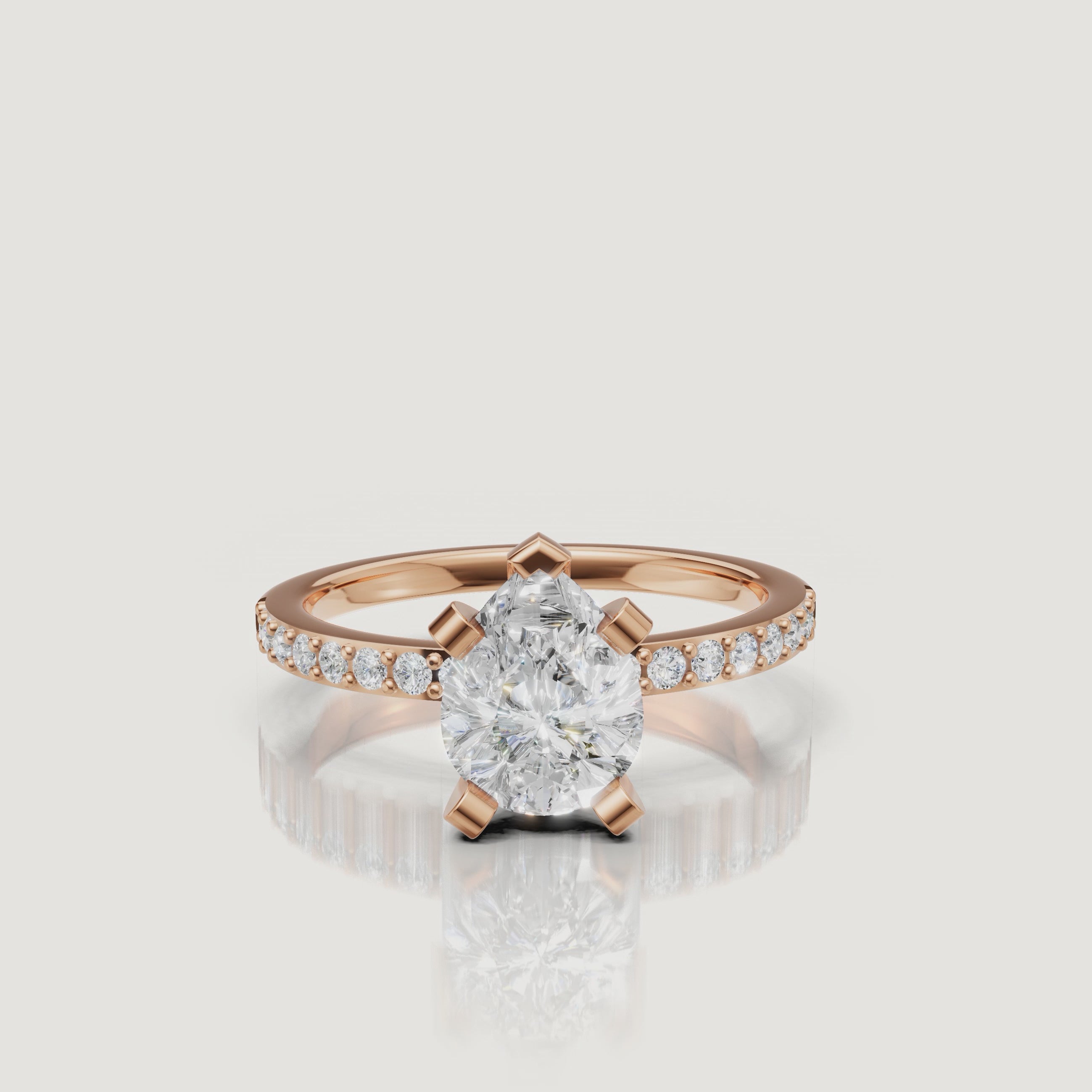 Cinematic close-up of the Lyra rose gold pear cut diamond ring, showcasing the warm metal tones and the superior light performance of the pear-shaped center stone.
