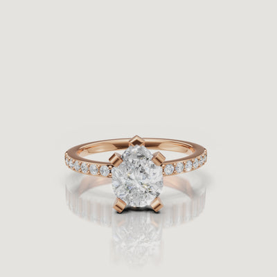 Cinematic close-up of the Lyra rose gold pear cut diamond ring, showcasing the warm metal tones and the superior light performance of the pear-shaped center stone.