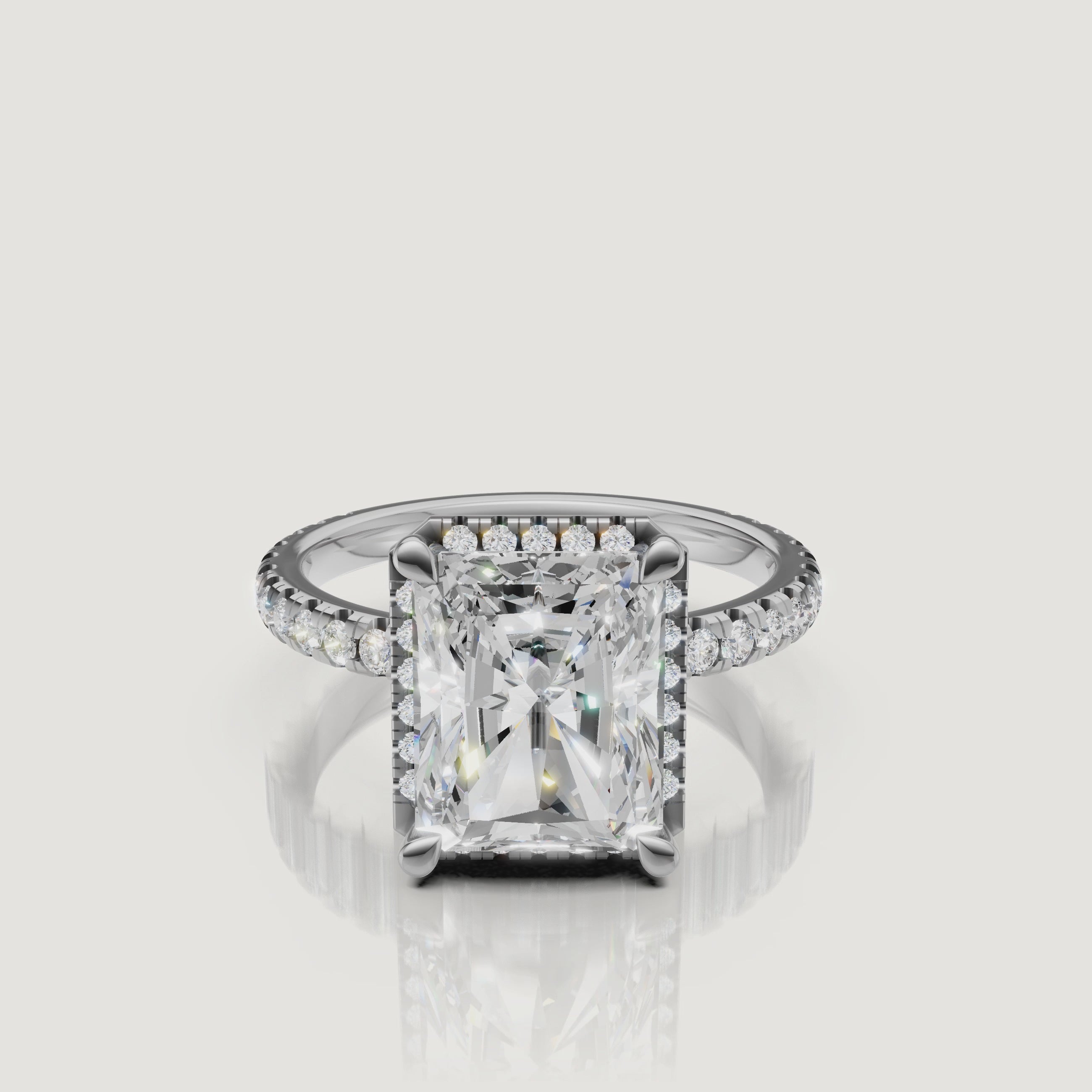 Lifestyle video of the Isabella model wearing a Raul Diamonds white gold Radiant engagement ring, emphasizing the brilliant hidden halo and micro-pavé setting
