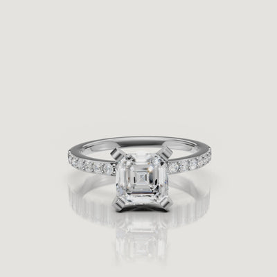 High-definition video showcase of the Raul Diamonds white gold Asscher cut engagement ring, focusing on the precision of the step-cut facets and the continuous pavé sparkle.
