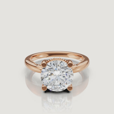 Close-up video of a rose gold round cut diamond ring by Raul Diamonds, capturing the romantic blush metal and the diamond’s exceptional fire.