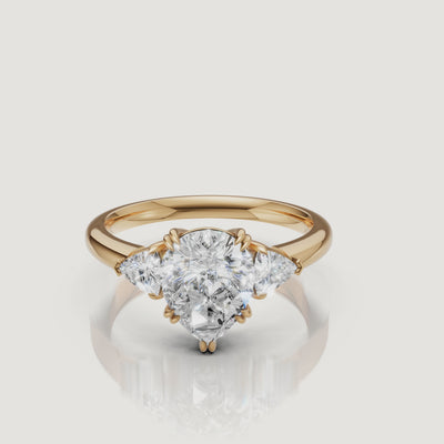 video of pear cut lab grown diamond engagement ring with trillion side stones in 14k yellow gold