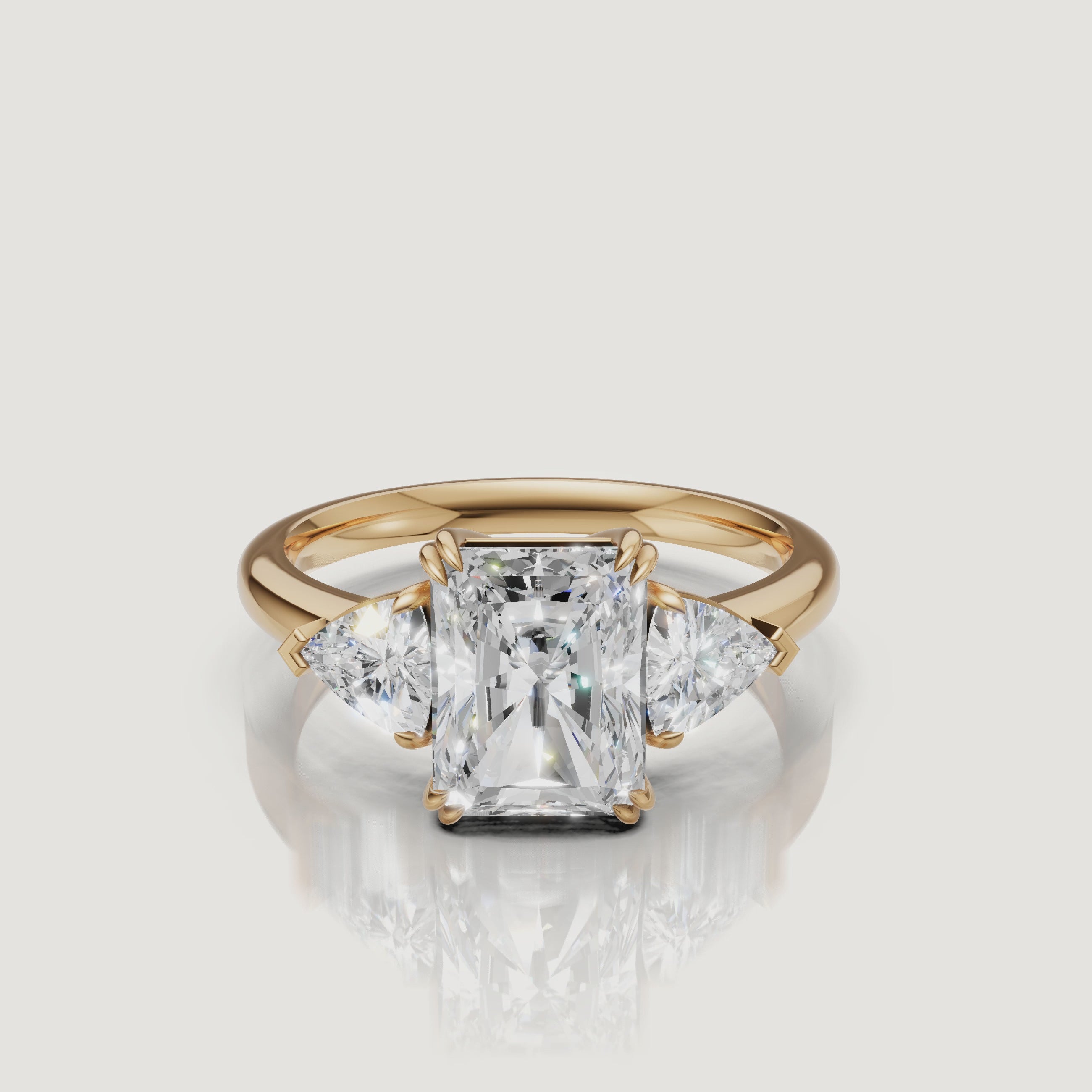 video of radiant cut lab grown diamond engagement ring with trillion side stones in 14k yellow gold