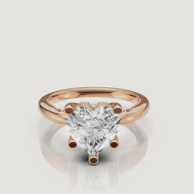 Close-up 4K video of a rose gold heart-shaped diamond ring by Raul Diamonds, highlighting the romantic blush metal and fire of the center stone