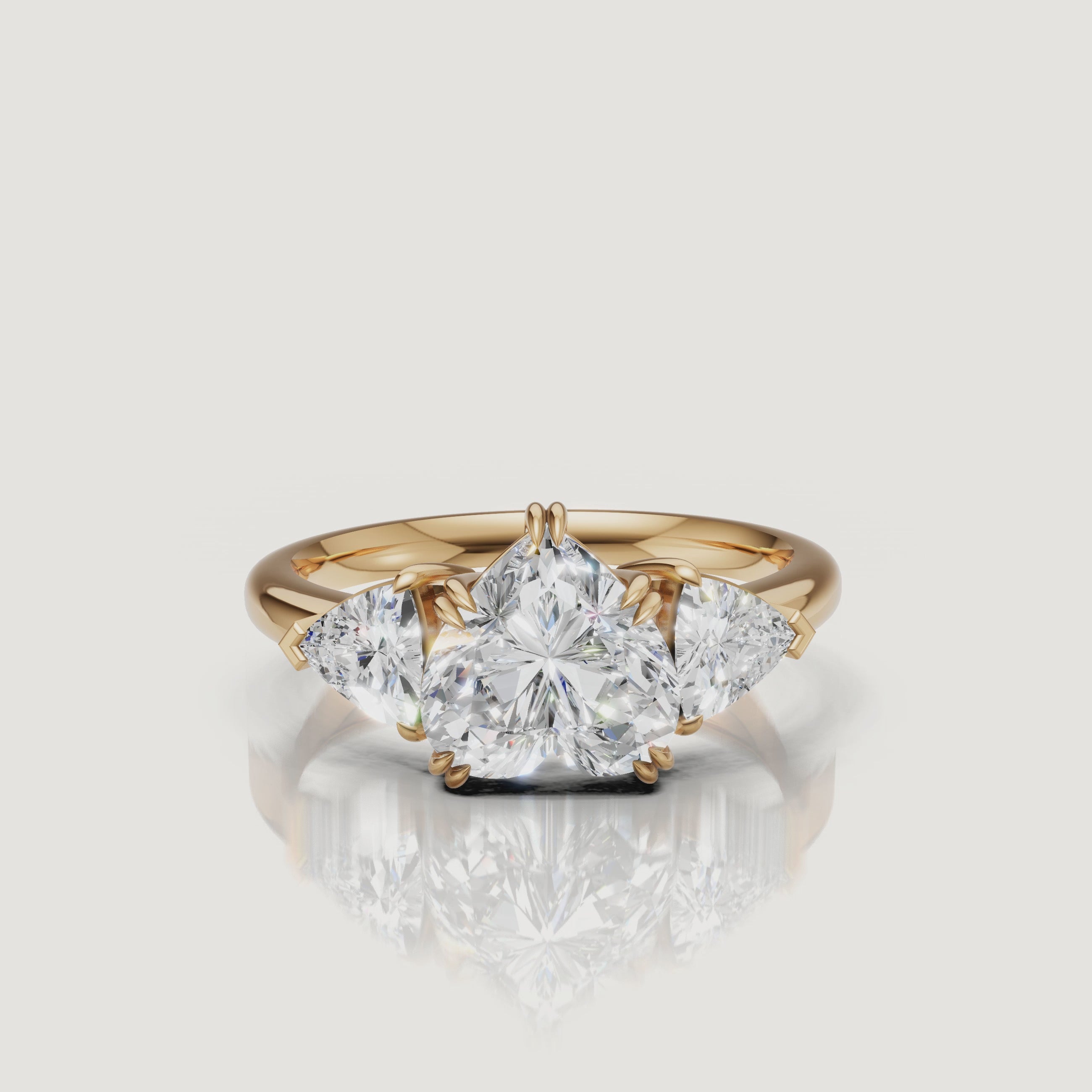 Cinematic 360-degree video showcase of a Raul Diamonds heart-cut diamond ring in 14k yellow gold, highlighting the sparkle of the trillion-cut side stones