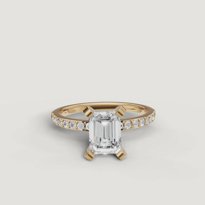 Video showcase of the Raul Diamonds emerald cut solitaire ring in yellow gold, featuring the hall-of-mirrors light reflection and sparkling pavé diamond band.