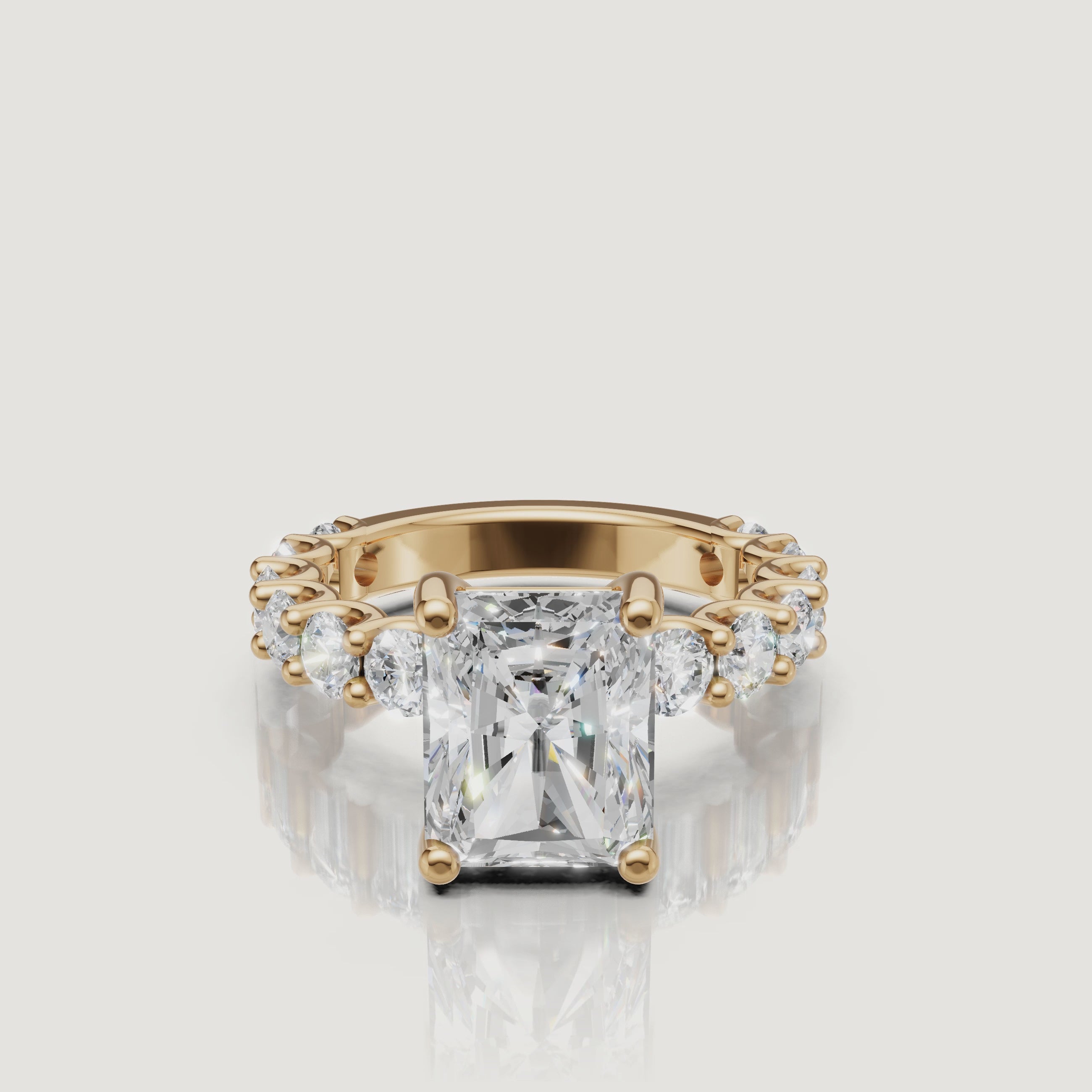 Side-profile video of a Raul Diamonds radiant-cut diamond ring in 18k yellow gold, highlighting the intricate scalloped basket and shared-prong eternity diamonds