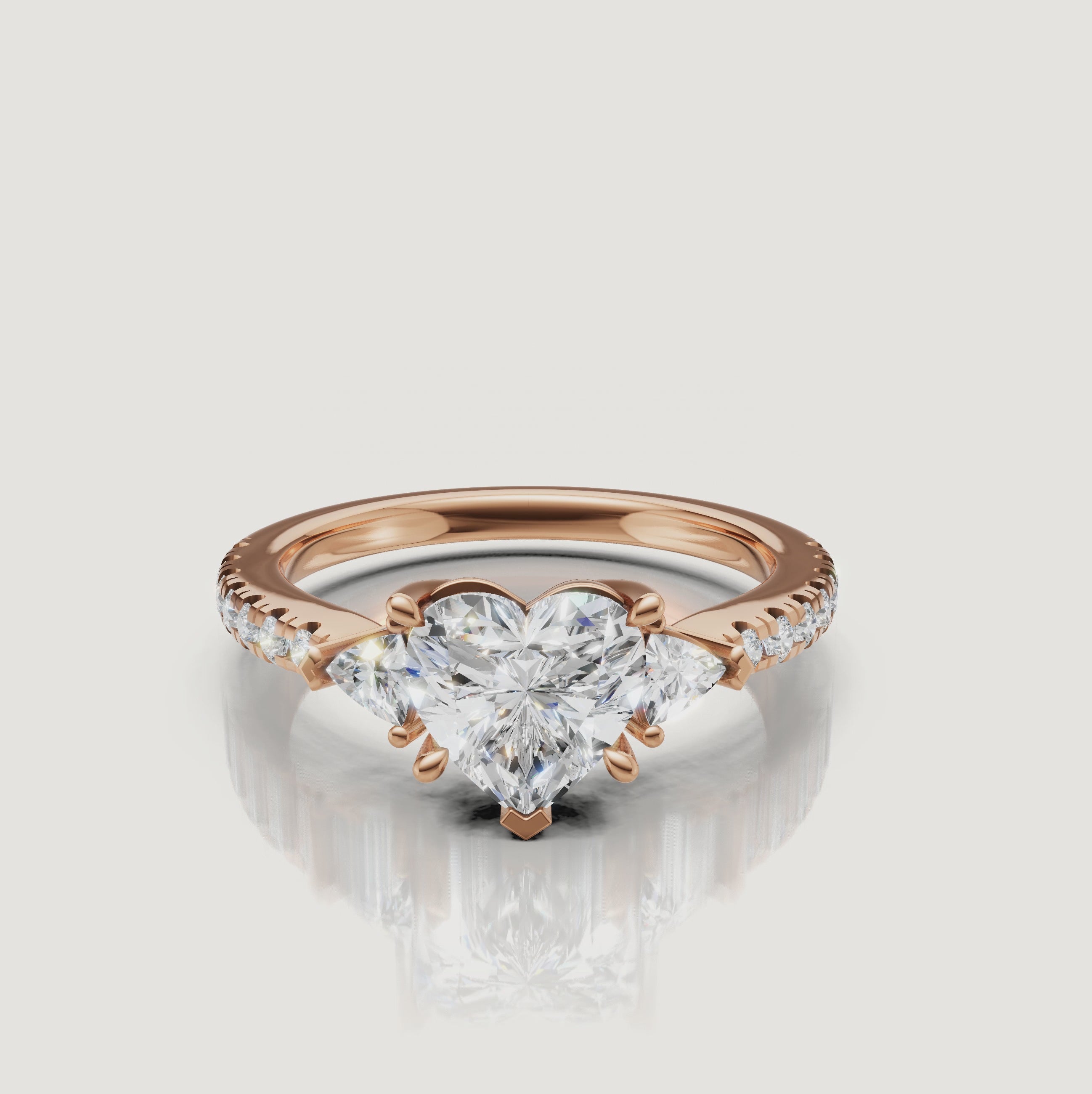 Cinematic video showcase of a Rual Diamonds three-stone heart diamond ring, capturing the light reflection and romantic sparkle of the center stone