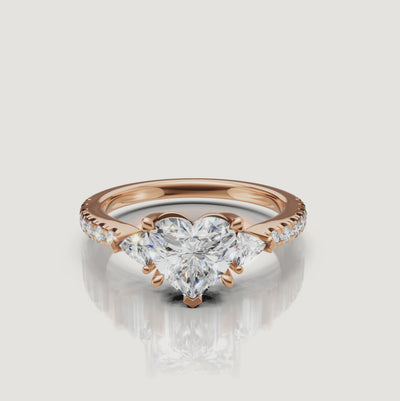 Cinematic video showcase of a Rual Diamonds three-stone heart diamond ring, capturing the light reflection and romantic sparkle of the center stone