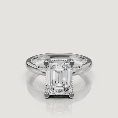 Macro video of a white gold emerald cut solitaire ring from Raul Diamonds, displaying the sharp geometric lines and brilliant white light performance.