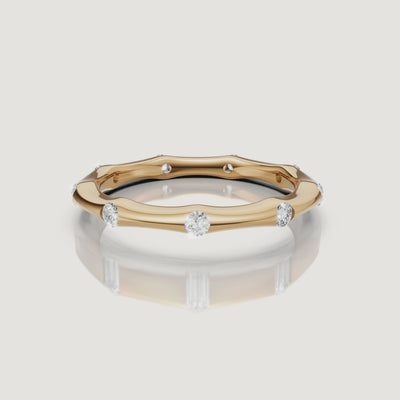 360 degree video of Raul Diamonds yellow gold curved diamond wedding band with bezel set round diamonds and minimalist luxury design