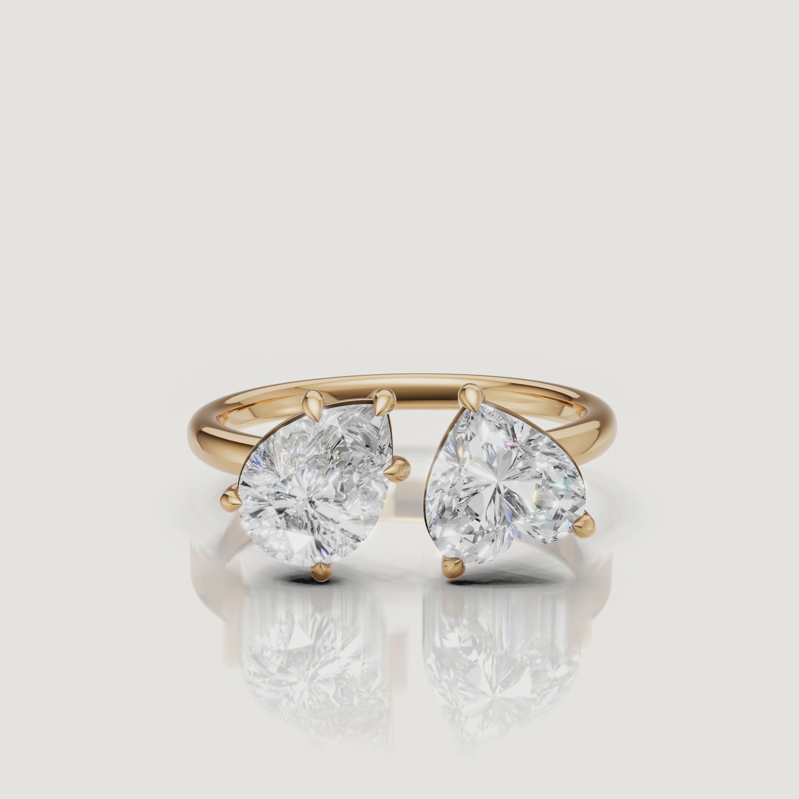 Yellow Gold Video Alt: Rotating video of Raul Diamonds yellow gold toi et moi ring with pear and emerald cut diamonds