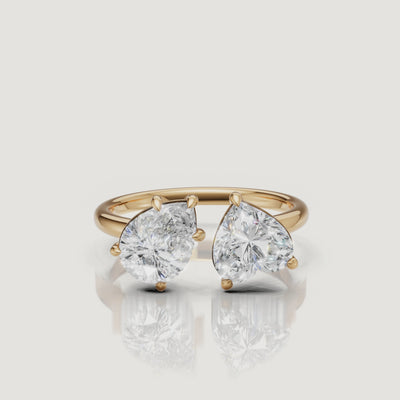 Yellow Gold Video Alt: Rotating video of Raul Diamonds yellow gold toi et moi ring with pear and emerald cut diamonds