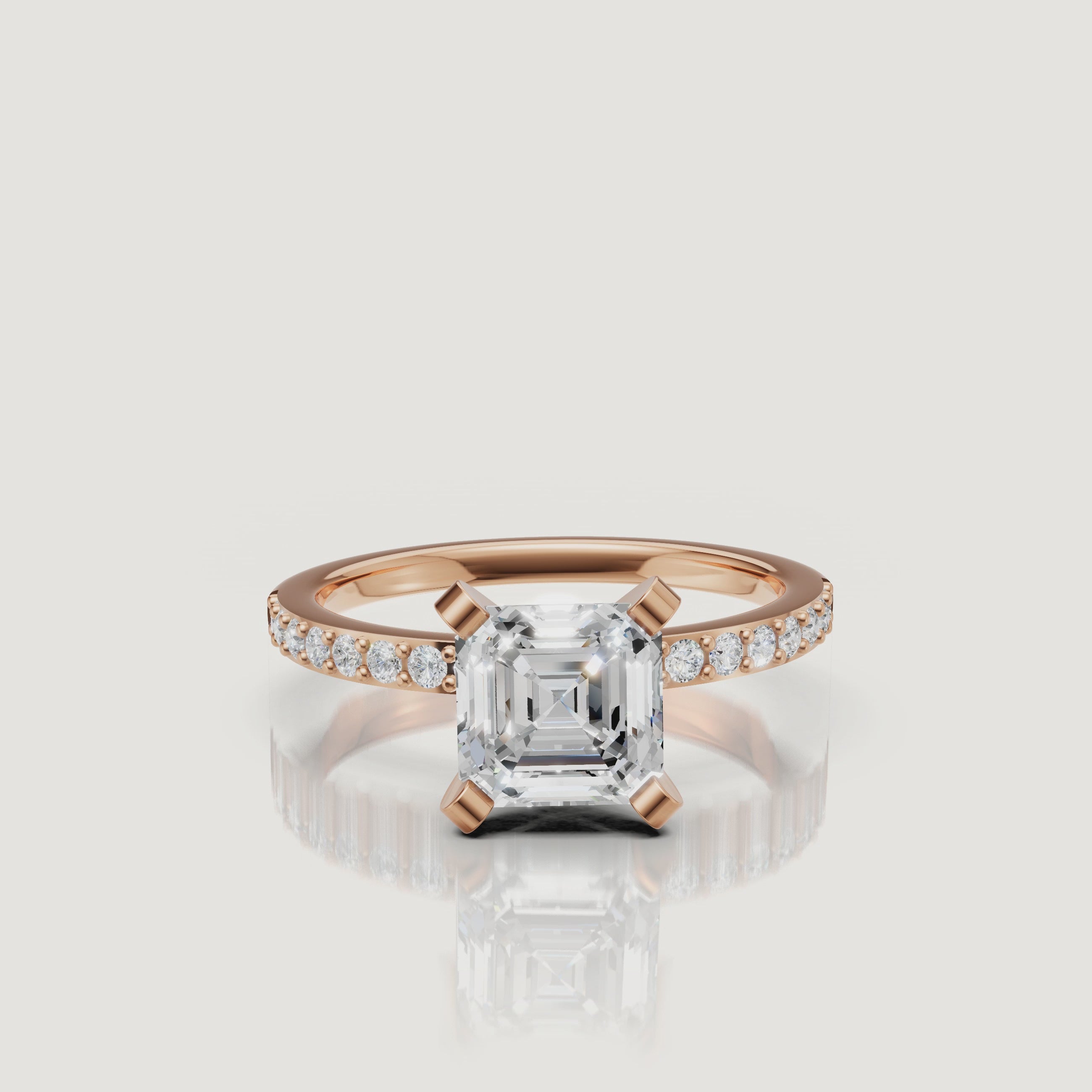 Cinematic close-up of the Aurora Asscher cut diamond ring in rose gold, highlighting the contrast between the warm metal and the brilliant white pavé diamonds.