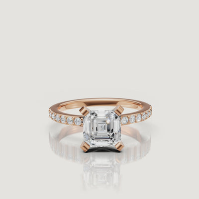 Cinematic close-up of the Aurora Asscher cut diamond ring in rose gold, highlighting the contrast between the warm metal and the brilliant white pavé diamonds.