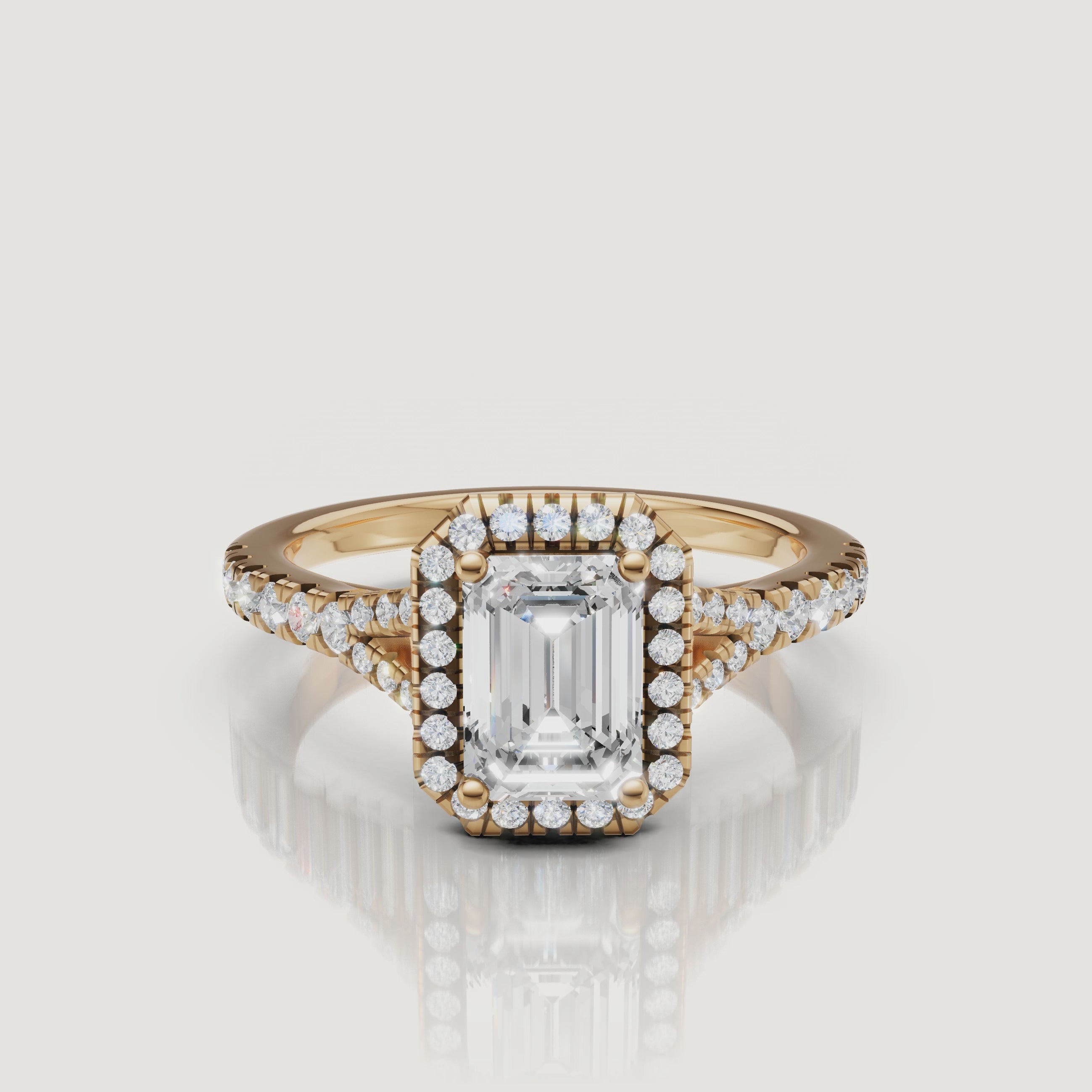 A cinematic 360-degree view of an emerald cut diamond halo ring in 18k yellow gold by Raul Diamonds, showcasing the step-cut facets and shimmering split shank