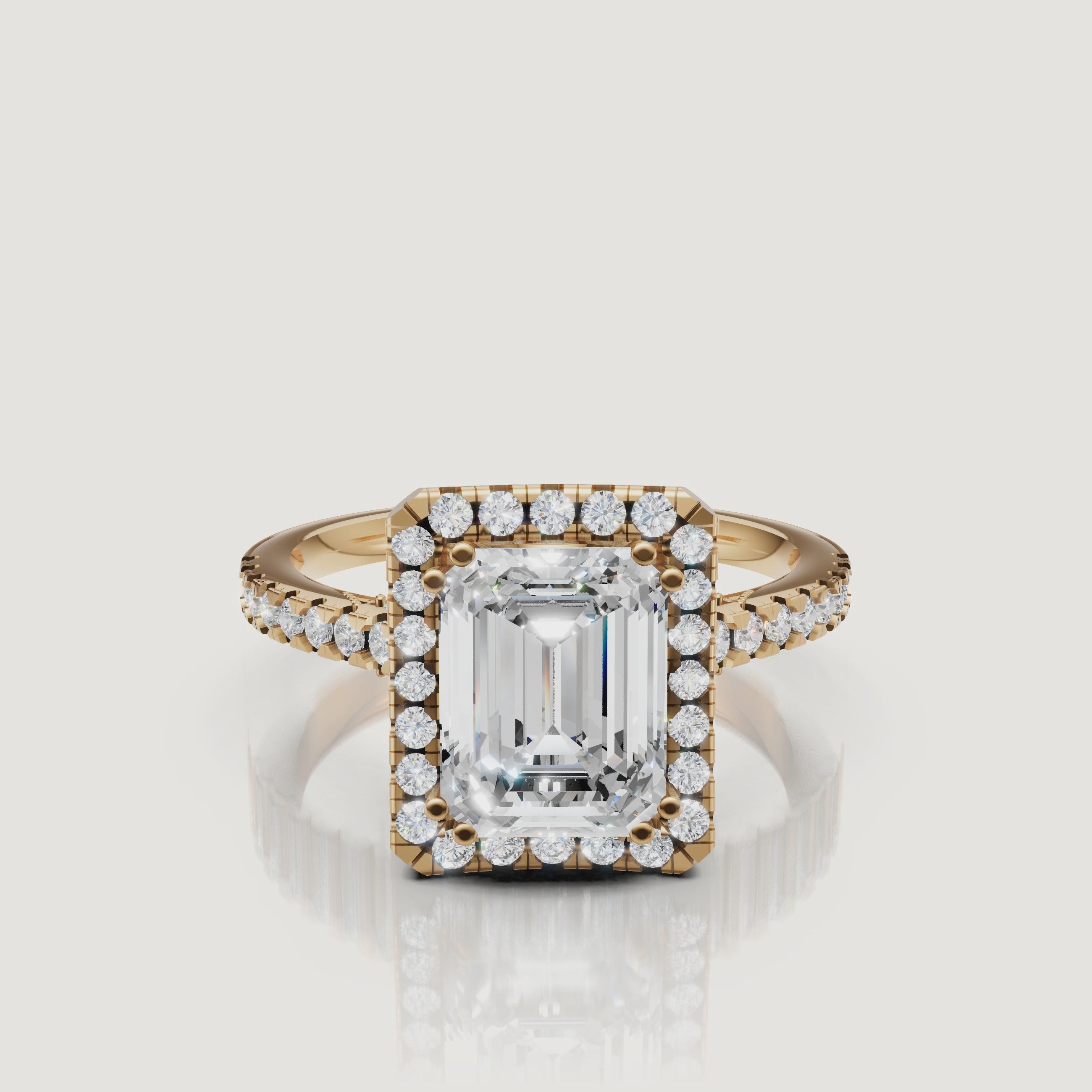 Video of emerald cut lab grown diamond halo engagement ring in 14K yellow gold with pavé band by Raul Diamonds