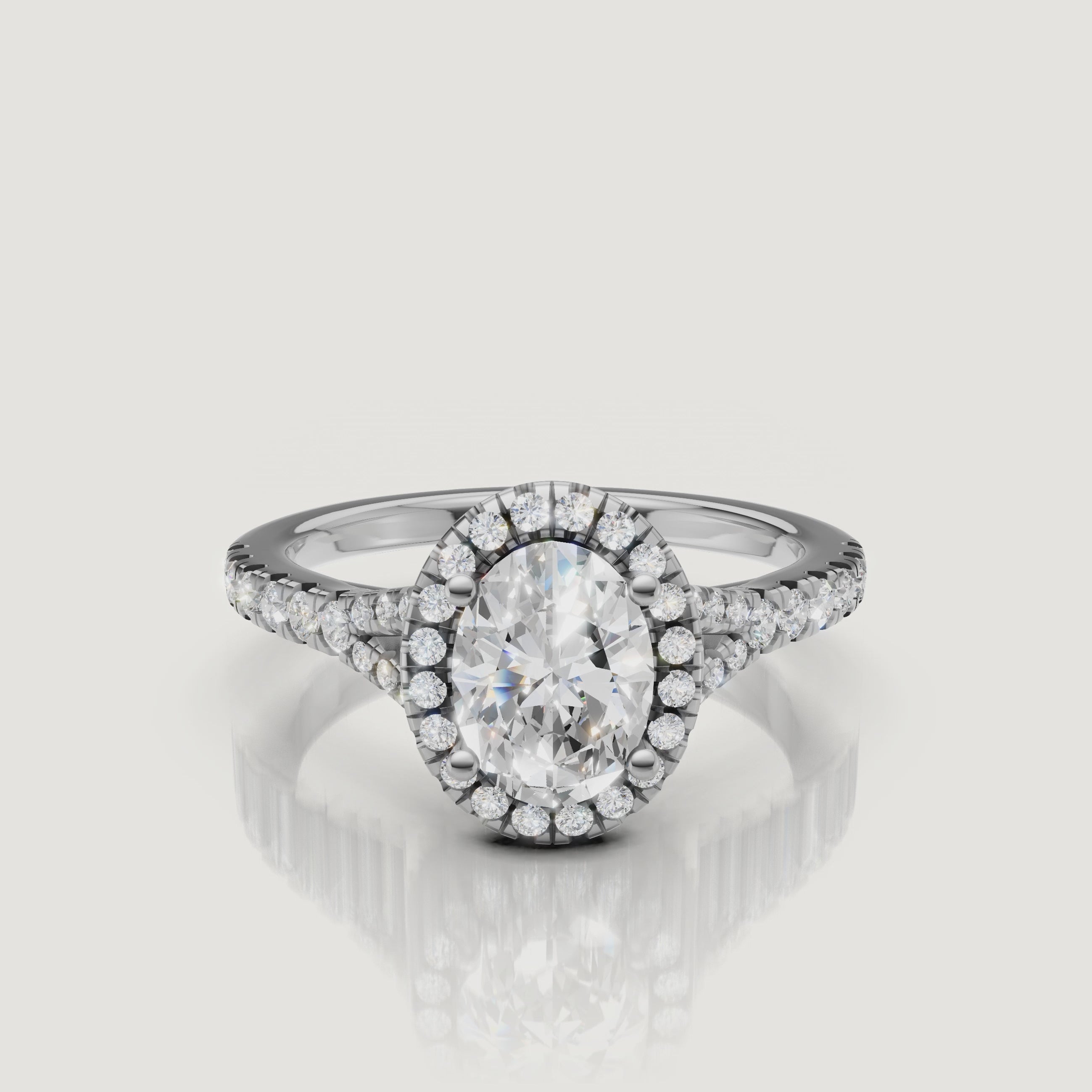 High-definition video of a white gold oval cut diamond ring with a pavé halo, demonstrating the superior brilliance and fire of the Raul Diamonds center stone