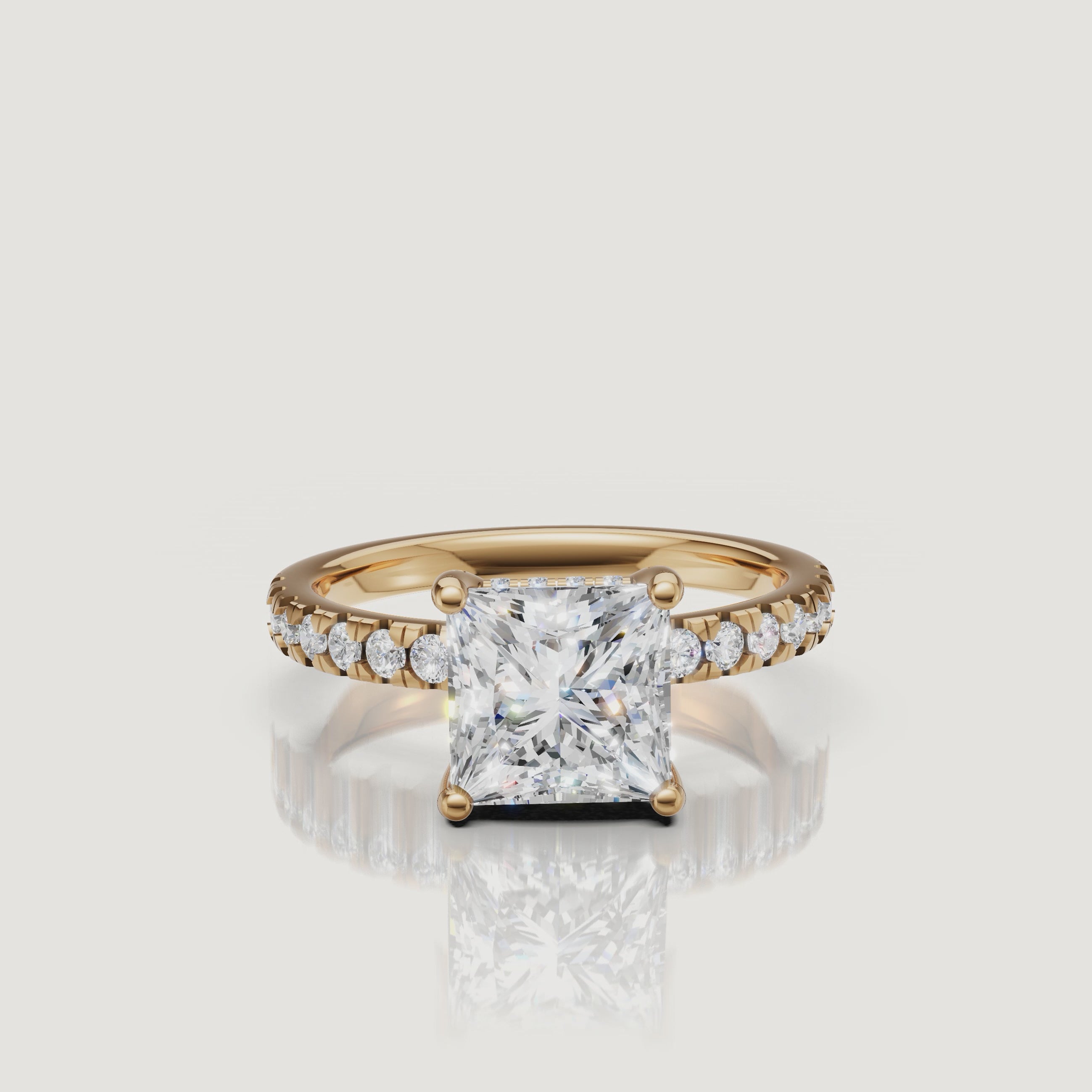 360-degree video showcase of a Raul Diamonds princess-cut engagement ring in yellow gold, highlighting the sharp geometric facets and the continuous sparkle of the pavé diamonds