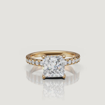 360-degree video showcase of a Raul Diamonds princess-cut engagement ring in yellow gold, highlighting the sharp geometric facets and the continuous sparkle of the pavé diamonds
