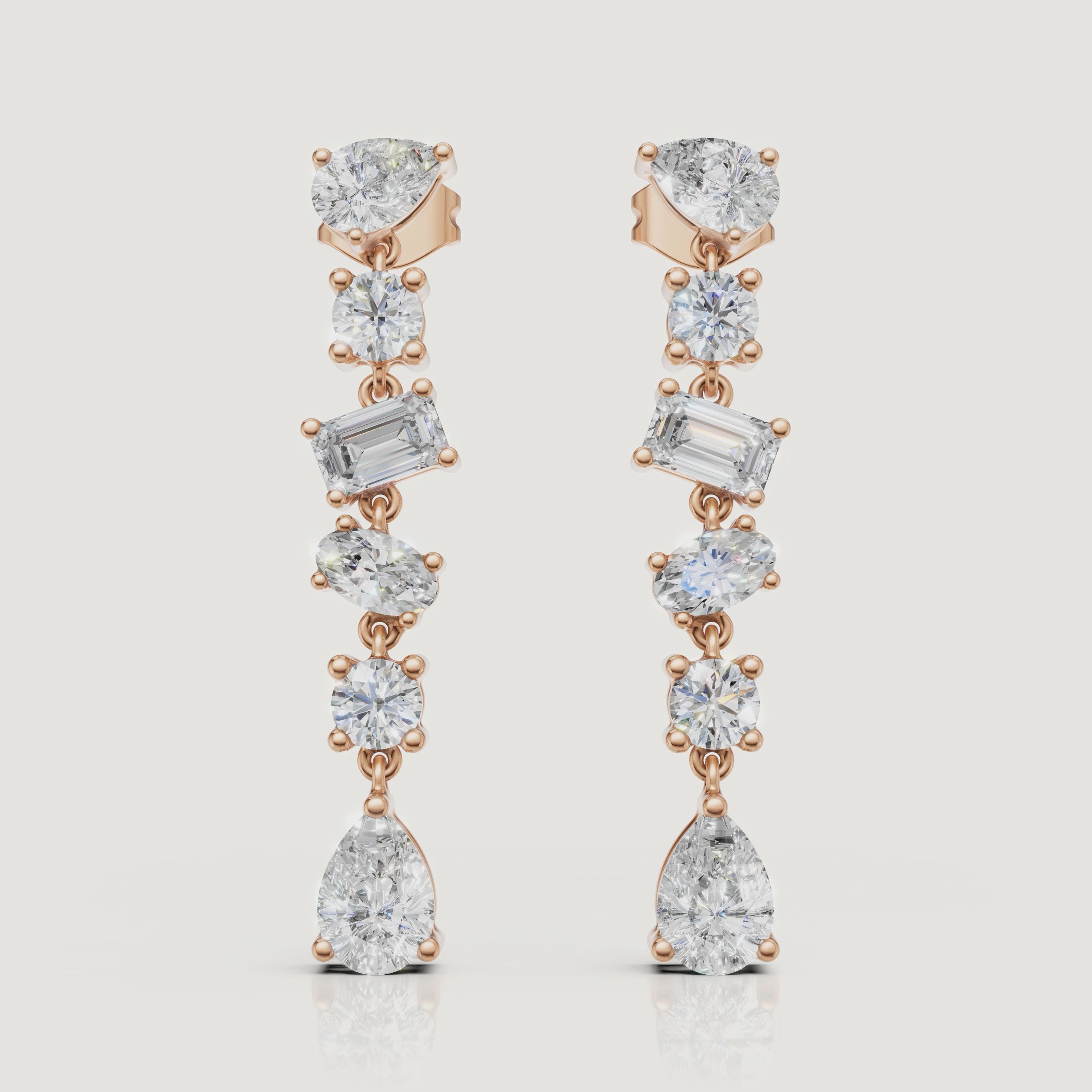 Yellow gold multi shape diamond drop earrings video showcasing pear and emerald cut brilliance by Raul Diamonds