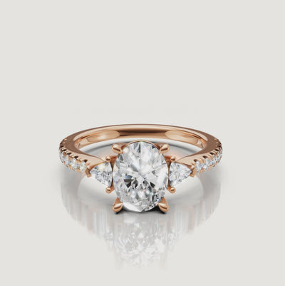 Cinematic close-up of a Rual Diamonds three-stone oval diamond ring, capturing the sparkle and light performance of the pavé-set band.