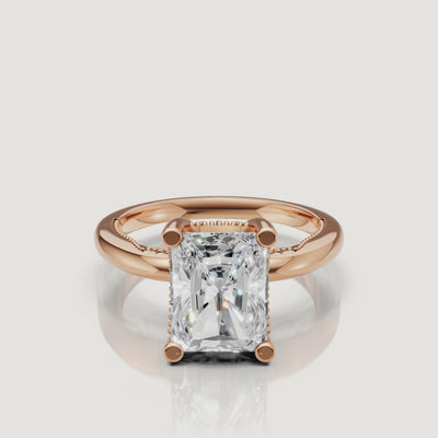 Close-up video of a rose gold radiant cut diamond ring by Raul Diamonds, capturing the romantic blush metal and intense light performance