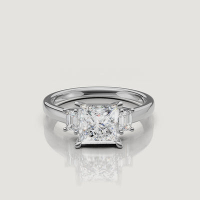 Detailed video walkthrough of the white gold princess cut trilogy ring from Raul Diamonds, demonstrating the brilliant light performance of the three-stone setting with baguette accents.