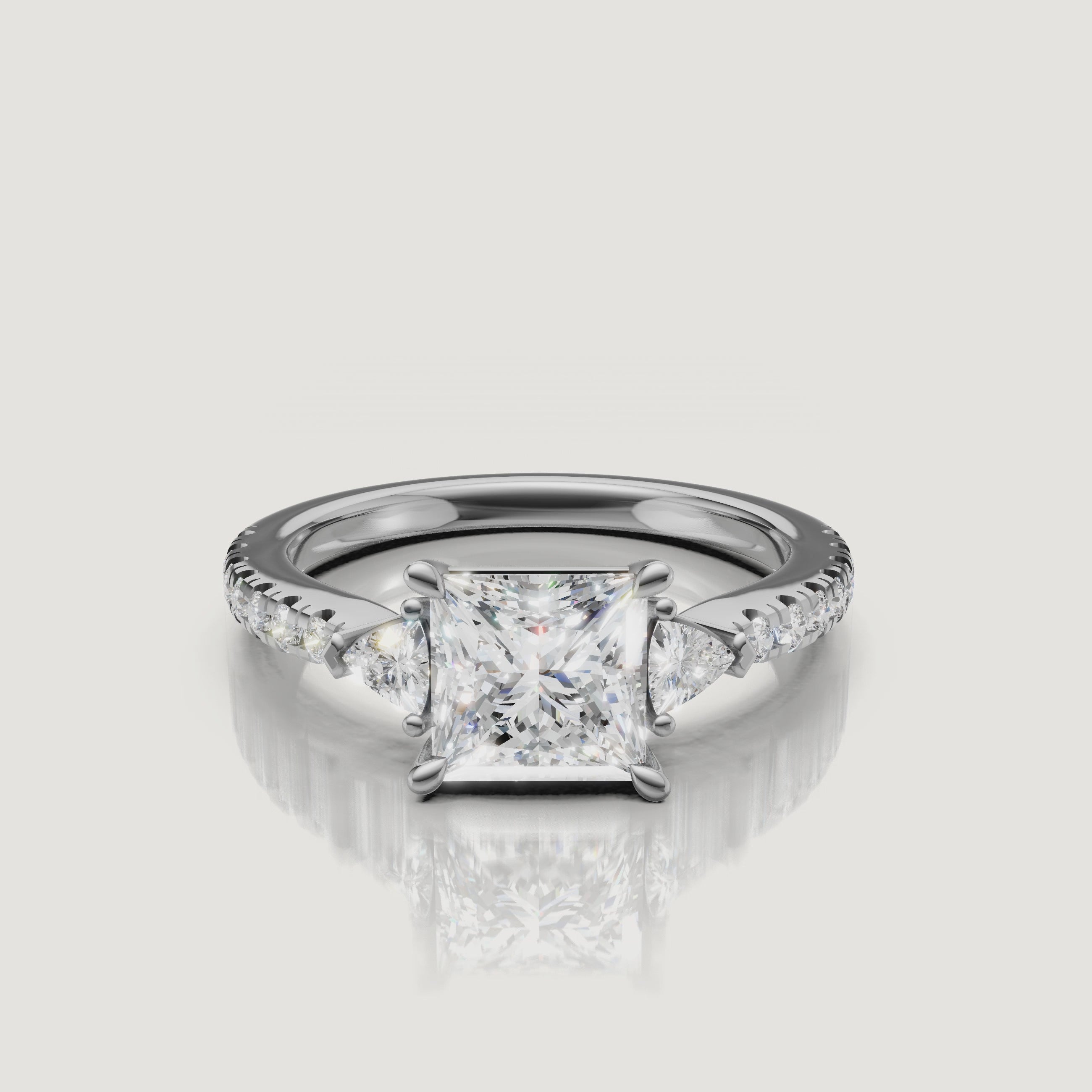 Lifestyle video of a model wearing a Rual Diamonds princess-shaped diamond ring, demonstrating the bold, modern profile and exceptional brilliance of the three-stone design