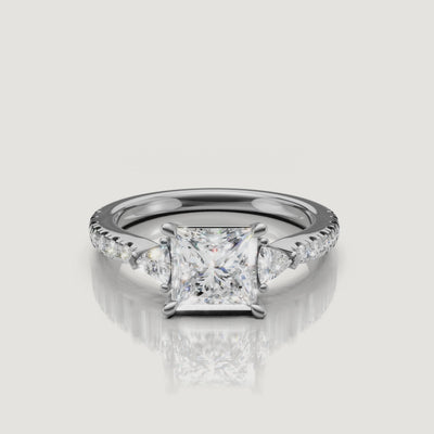 Lifestyle video of a model wearing a Rual Diamonds princess-shaped diamond ring, demonstrating the bold, modern profile and exceptional brilliance of the three-stone design