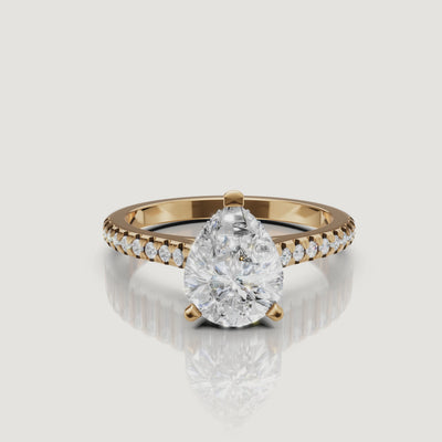 360 view of pear cut lab grown diamond pavé engagement ring in 14K yellow gold by Raul Diamonds