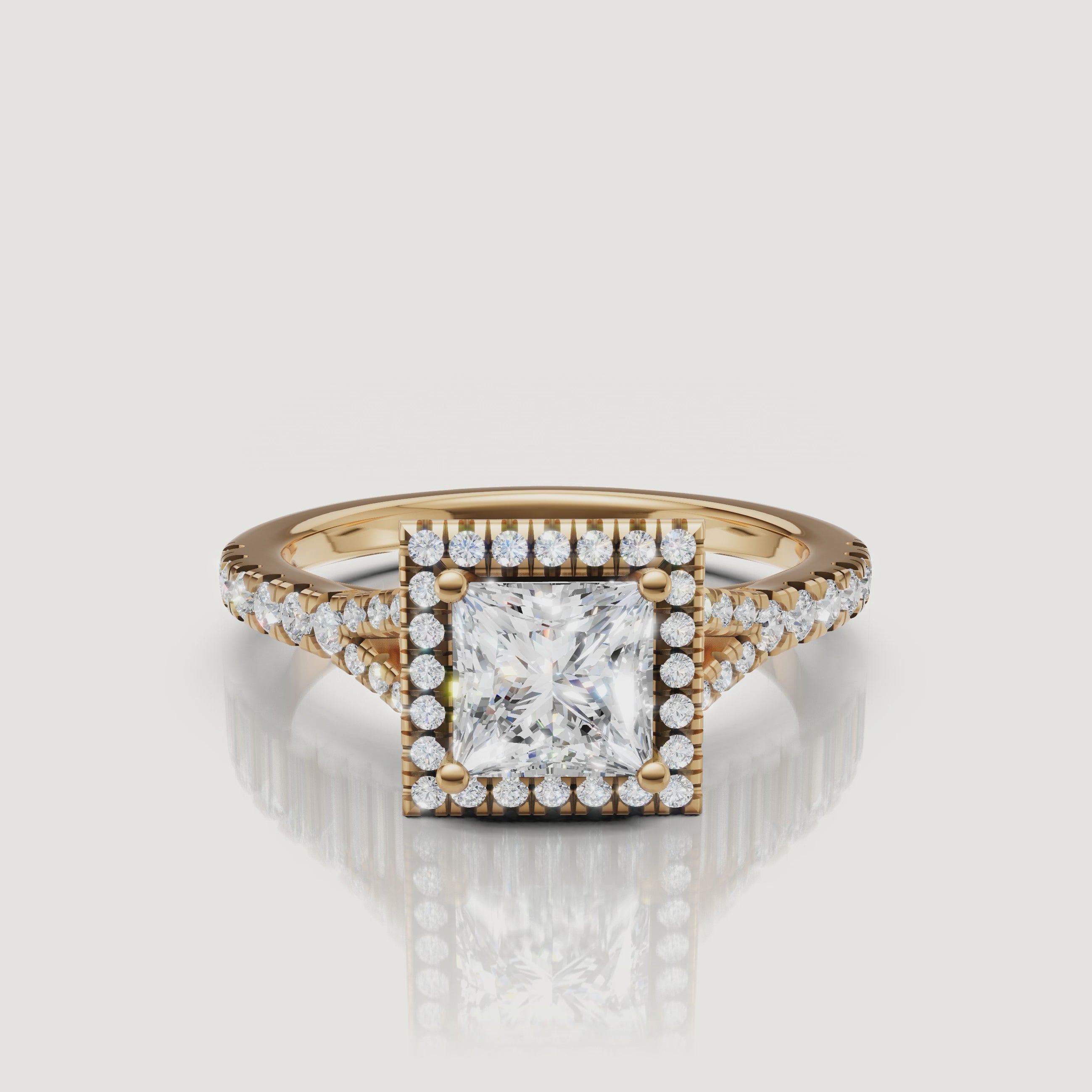 A high-definition 360-degree video of a Raul Diamonds princess cut diamond ring in yellow gold, highlighting the sharp corners of the halo and the sparkling split shank.